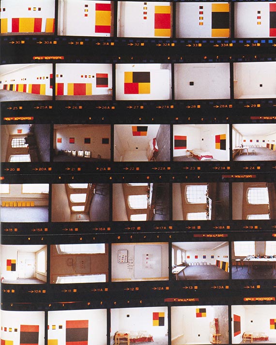 Illustration  for: Palermo's studio in Düsseldorf, 1977, taken by Imi Knoebel immediately after Palermo's death. On the walls next to Palermo's “To the people to New York City” are the last two paintings, “Untitled (4 parts)” and “Untitled (8 parts)”. © VG Bild-Kunst, Bonn 2025