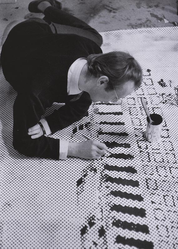 Illustration for: Sigmar Polke working on the grid painting <i>Häuserfront</i> (building facade), 1967 in his Düsseldorf studio, photo: unknown. © The Estate of Sigmar Polke, Cologne/ VG Bild-Kunst, Bonn 2026